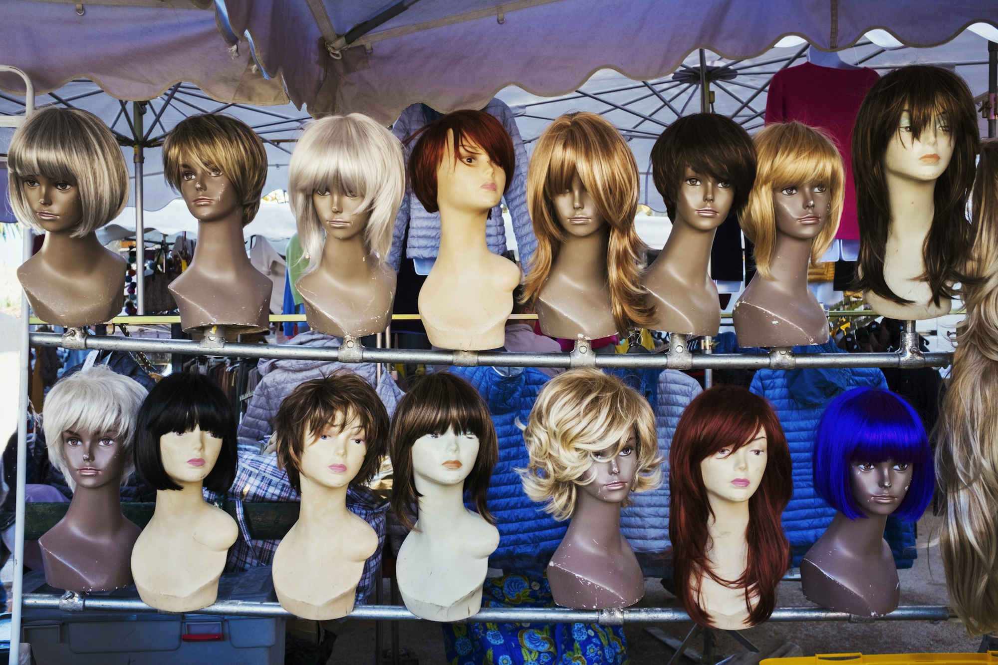 A wig stall, female mannequin heads and display of wigs.