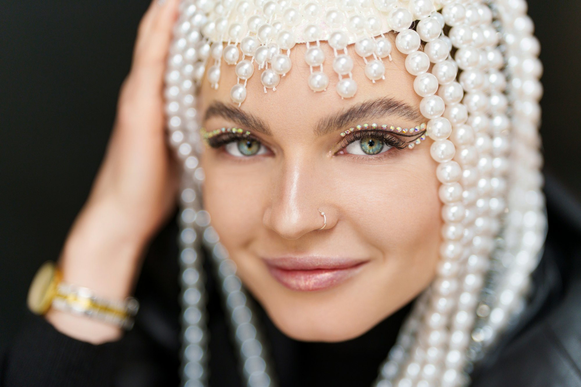 Happy woman with a wig of pearls and make up